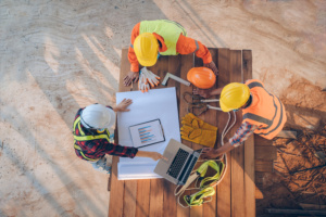 team engineer architects working meeting discussing designing planning measuring layout building blueprints construction site top view construction concept 300x200 - SOR Konstruksi