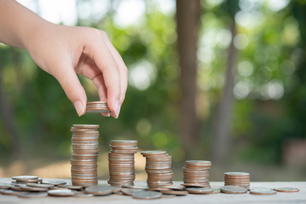 saving money concept preset by male hand putting money coin stack growing business arrange coins into heaps with hands content about money 1024x683 - How Can Warehouse Management Software Improve Your Business?