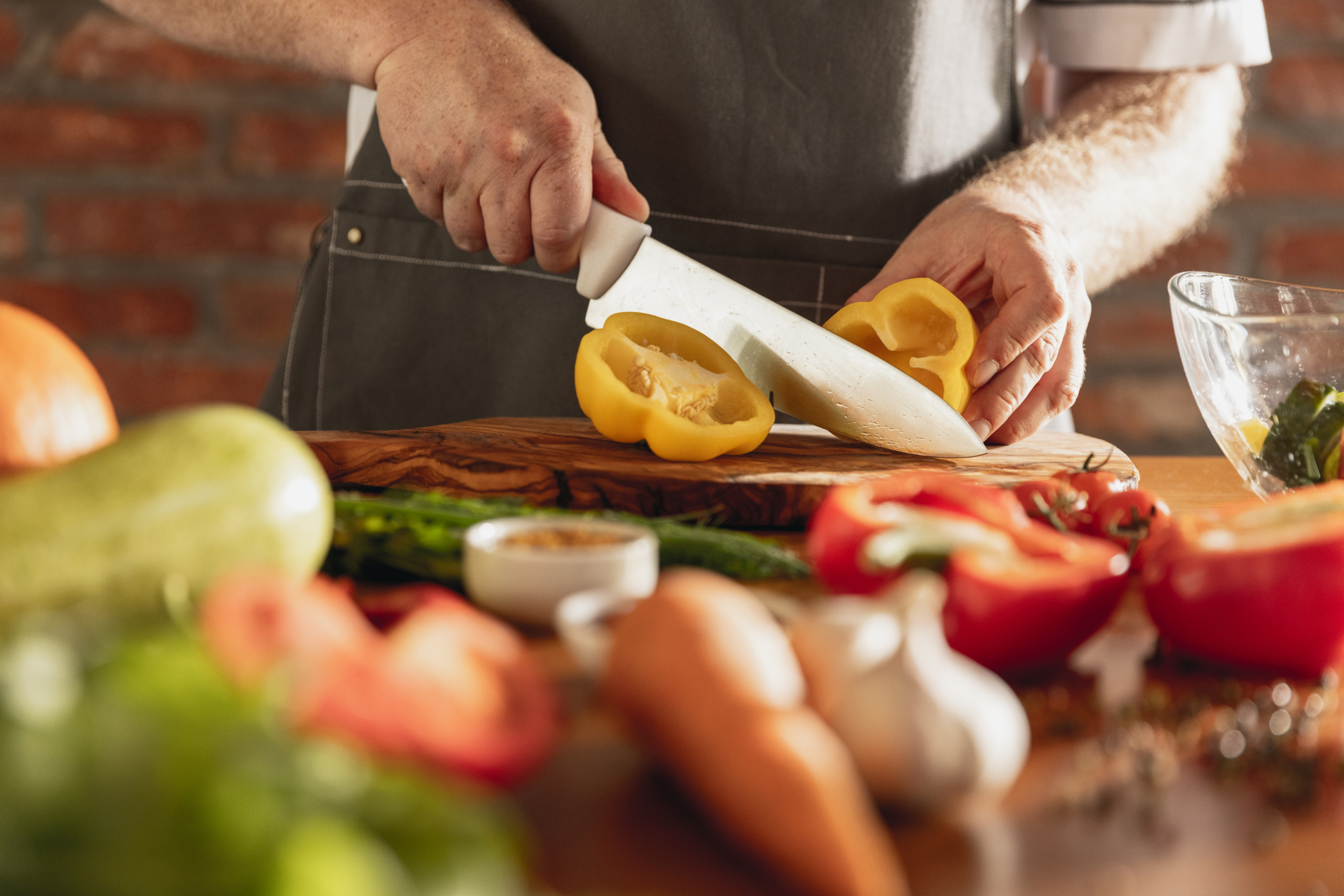 hands chef cutting vegetables his kitchen scaled - Sustainability Strategies in F&B Industry